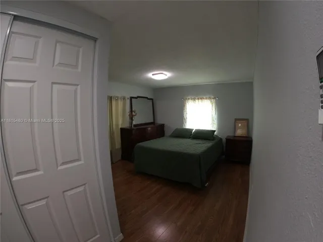 a bathroom with a granite countertop toilet and a sink
