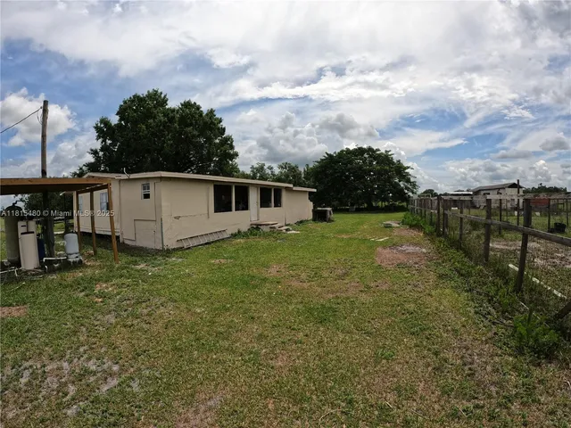 a view of a pathway with a wrought fence