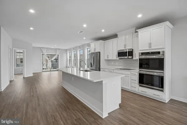 a kitchen with stainless steel appliances a stove sink and refrigerator
