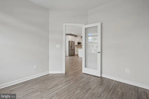 a view of an empty room with wooden floor