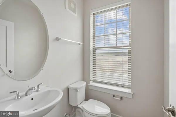a bathroom with a sink toilet and mirror
