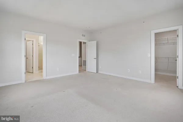 a view of an empty room and closet area