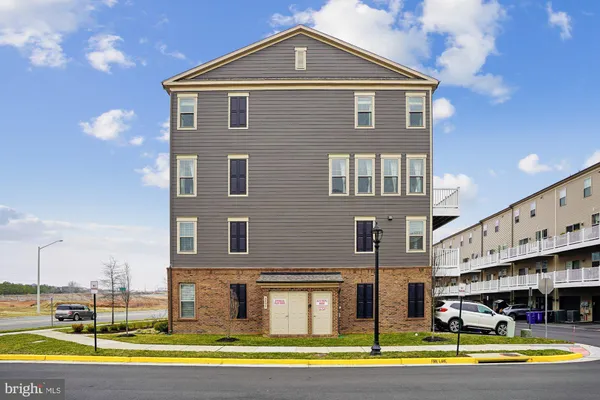 a front view of a building with a yard
