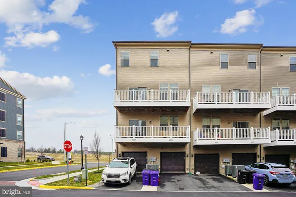 a view of building with car parked