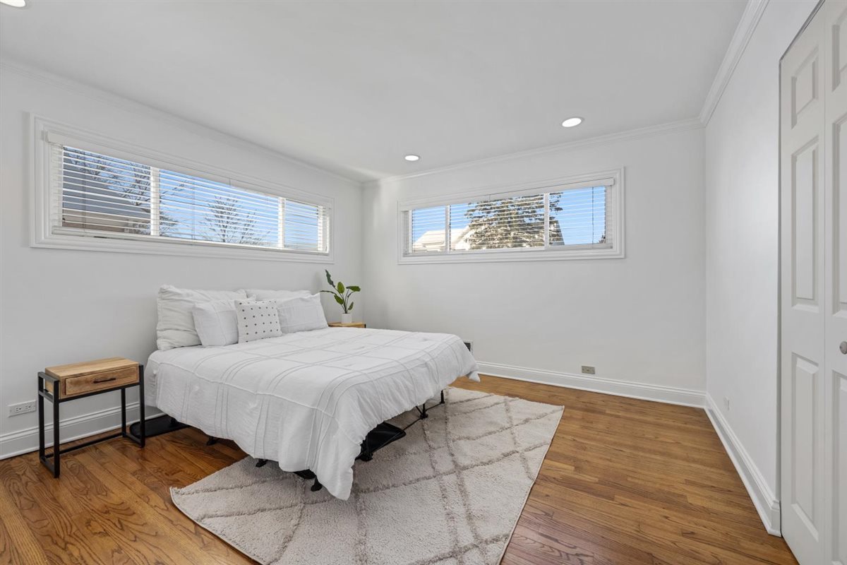 1821 George Court Glenview, IL 60025 - Photo 17 of 24 a bedroom with a bed and a night stand