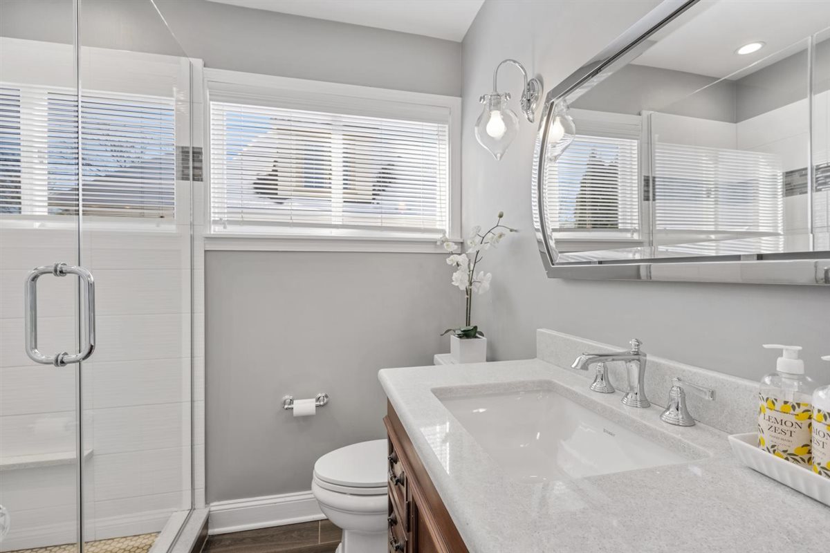 1821 George Court Glenview, IL 60025 - Photo 18 of 24 a bathroom with a sink a toilet and a mirror