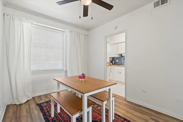 a view of a dining room with furniture and wooden floor