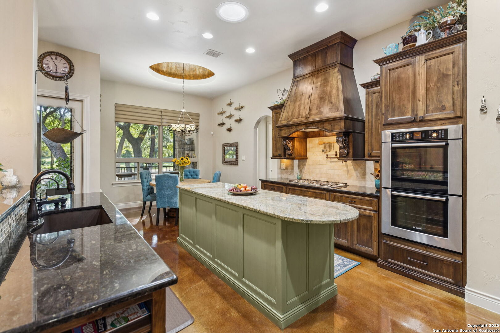 199 Shepherds Crook Helotes, TX 78023 - Photo 19 of 108 a kitchen with stainless steel appliances granite countertop a stove and a refrigerator