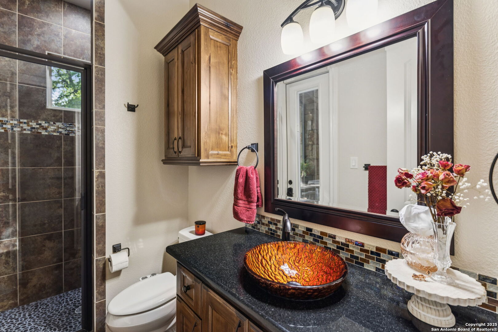199 Shepherds Crook Helotes, TX 78023 - Photo 39 of 108 a bathroom with a granite countertop sink and a mirror with toilet
