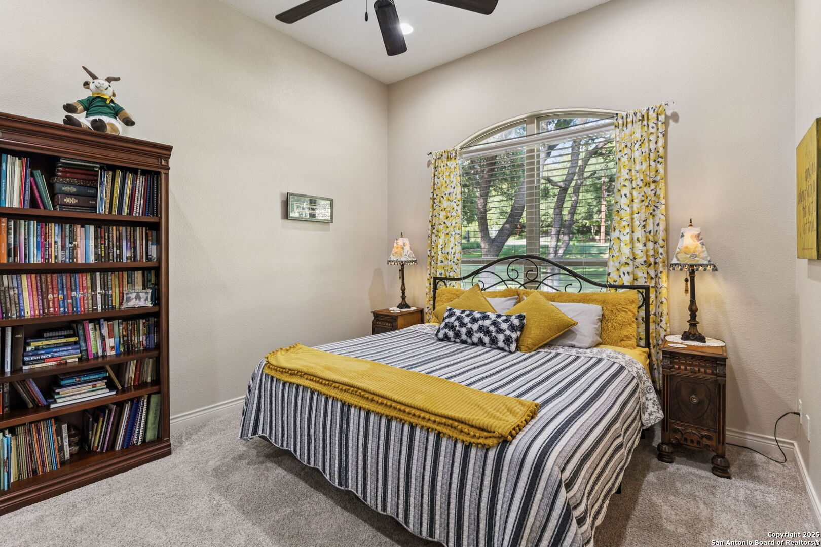 199 Shepherds Crook Helotes, TX 78023 - Photo 41 of 108 a bedroom with a bed a book shelf and a window