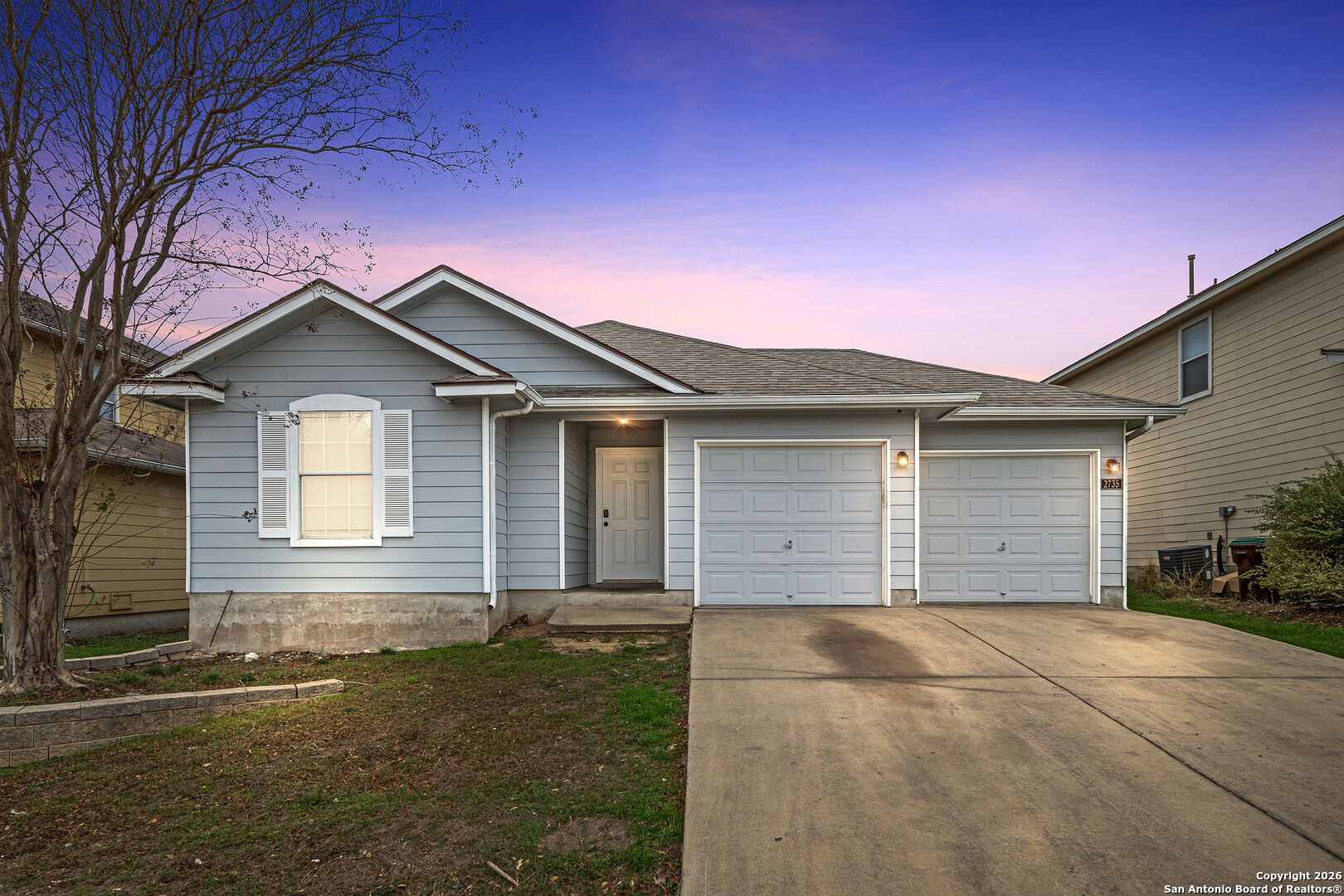a front view of a house with a yard and garage
