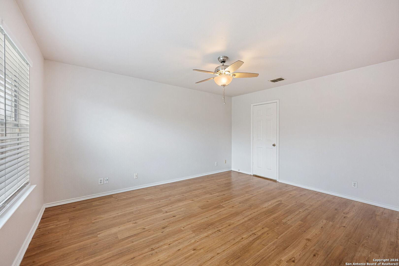 2735 Moon Rock Converse, TX 78109 - Photo 11 of 21 wooden floor in an empty room with a window