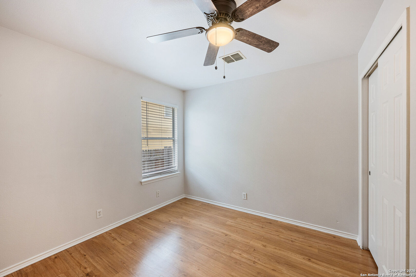 2735 Moon Rock Converse, TX 78109 - Photo 16 of 21 an empty room with chandelier fan and windows
