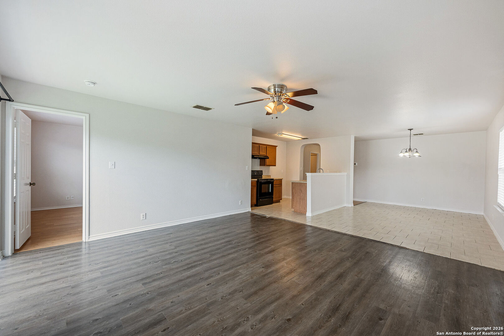 2735 Moon Rock Converse, TX 78109 - Photo 6 of 21 an empty room with wooden floor and ceiling fan