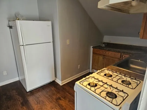 a stove top oven sitting inside of a kitchen