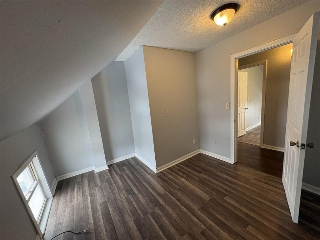 280 5th Street, Unit 3S Fall River, MA 02721 - Photo 3 of 12 an empty room with wooden floor and entrance