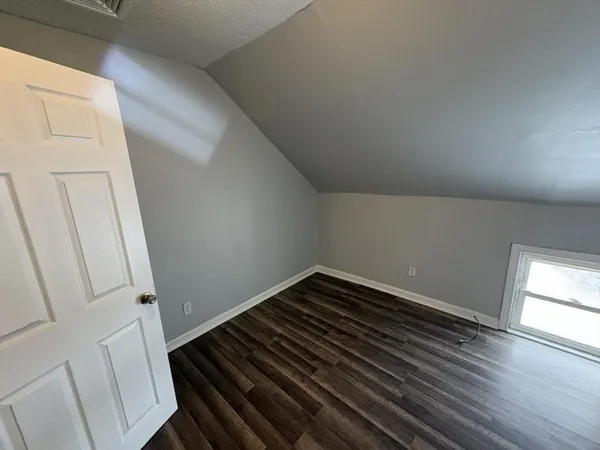 a view of a hallway view with wooden floor and staircase
