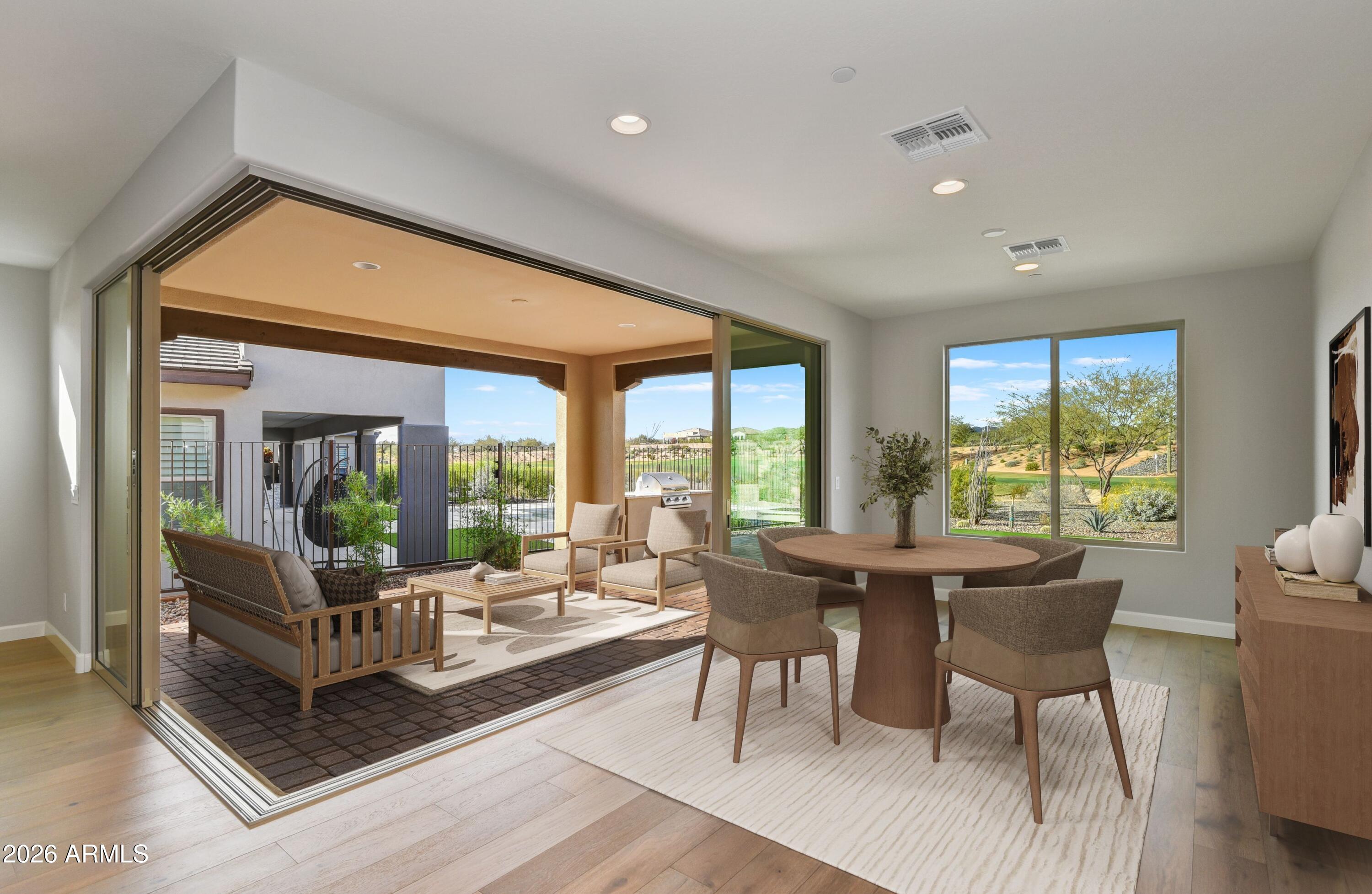 28702 North Camel Rock Court Rio Verde, AZ 85263 - Photo 2 of 38 a living room with furniture a large window and dining table