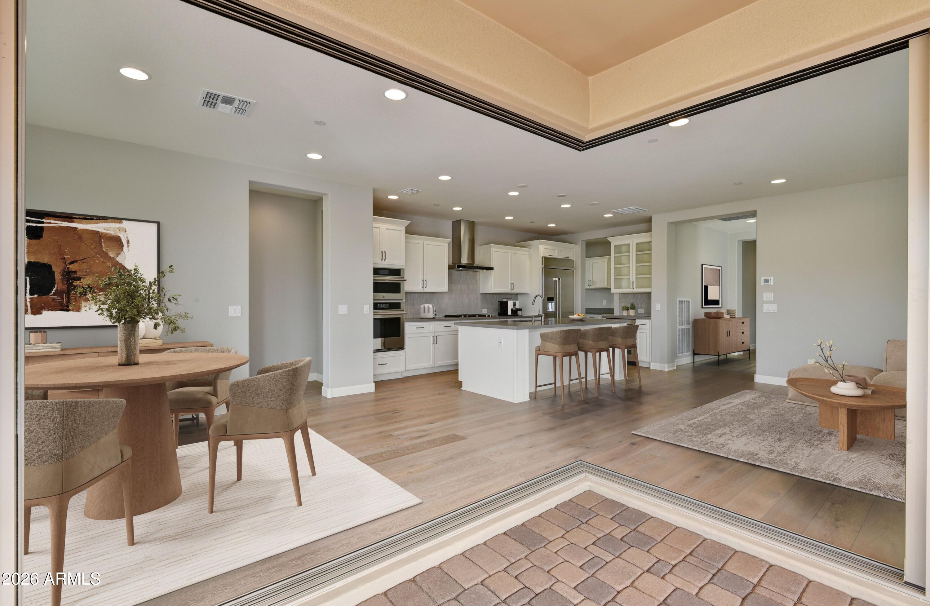 28702 North Camel Rock Court Rio Verde, AZ 85263 - Photo 3 of 38 a kitchen with stainless steel appliances kitchen island granite countertop a refrigerator and a dining table