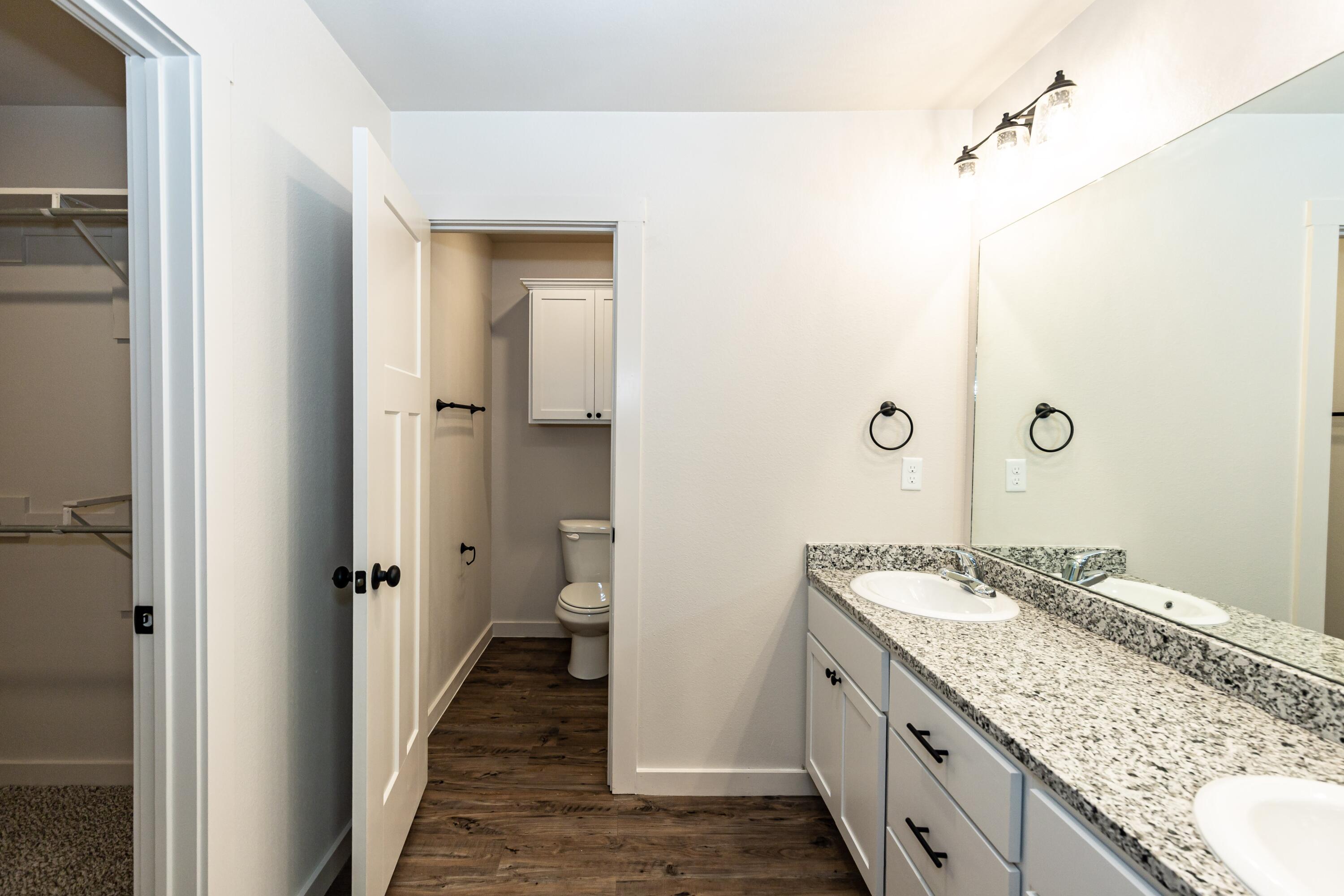 2529 138th Street Lubbock, TX 79423 - Photo 20 of 24 a spacious bathroom with a granite countertop sink and a mirror