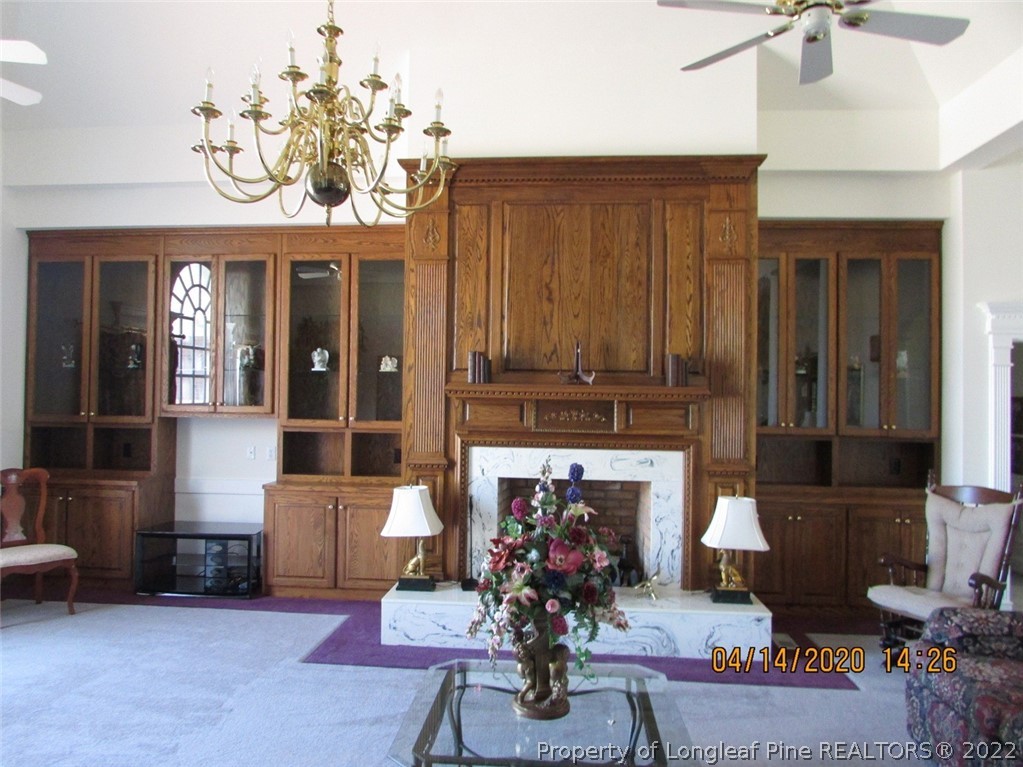 618 Leroy Autry Road Autryville, NC 28318 - Photo 11 of 35 a living room with furniture a fireplace and a chandelier