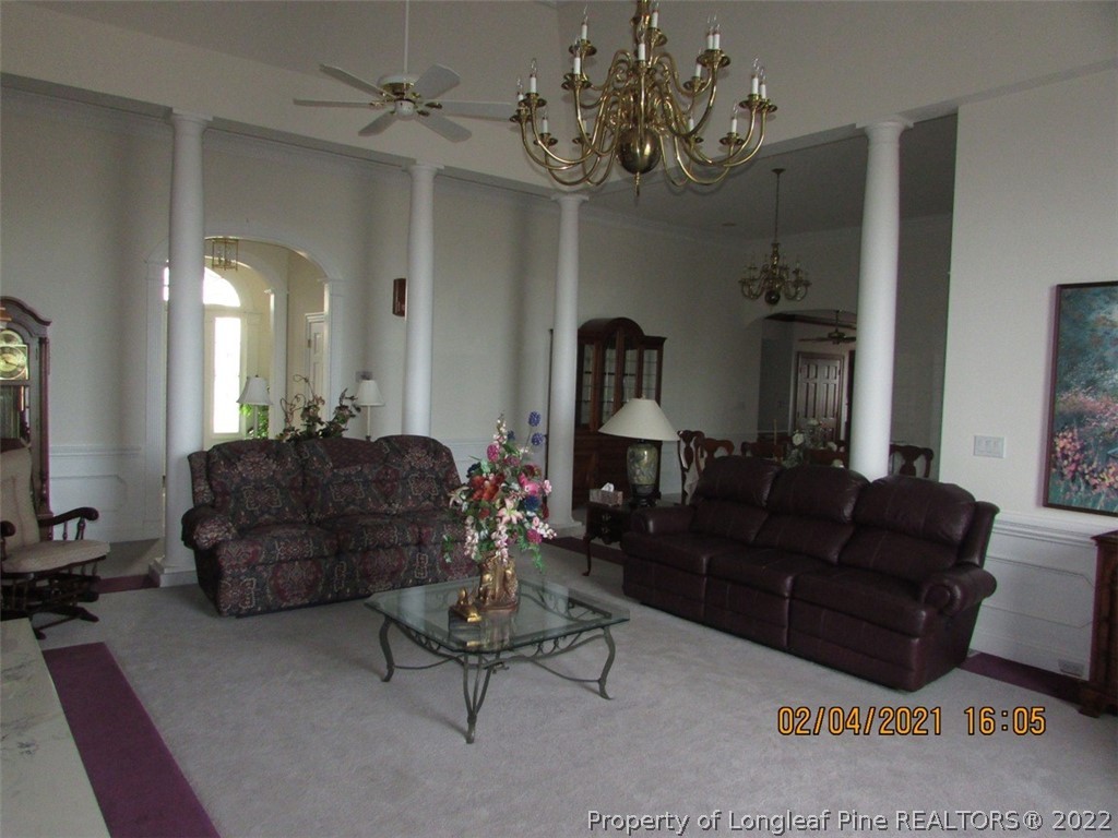 618 Leroy Autry Road Autryville, NC 28318 - Photo 12 of 35 a living room with furniture and a chandelier