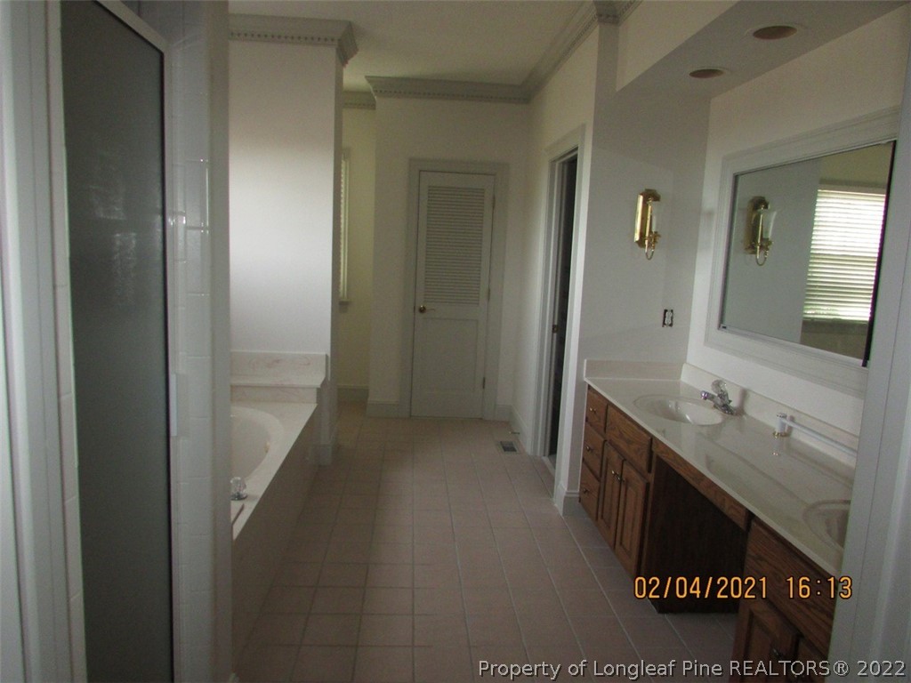 618 Leroy Autry Road Autryville, NC 28318 - Photo 16 of 35 a bathroom with a sink and a mirror