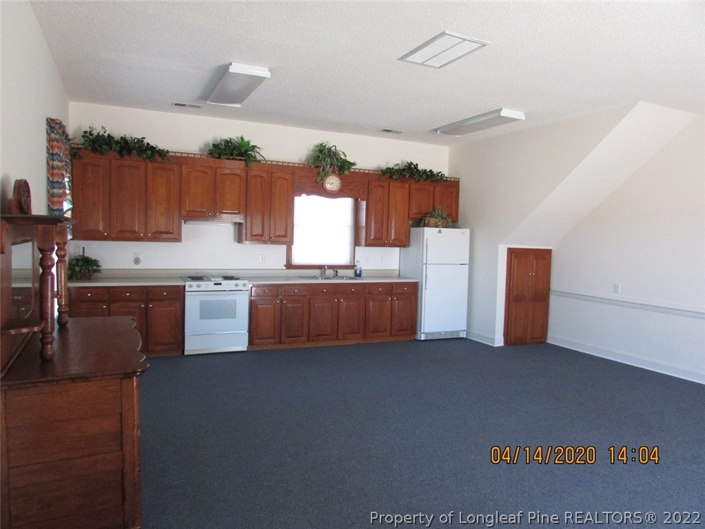 618 Leroy Autry Road Autryville, NC 28318 - Photo 35 of 35 a kitchen with cabinets and white appliances
