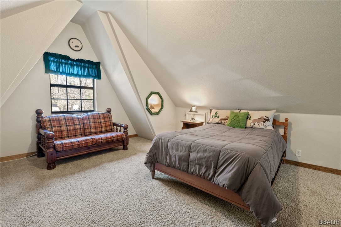 456 Riverside Avenue Sugarloaf, CA 92386 - Photo 12 of 19 a bedroom with a bed chair and window
