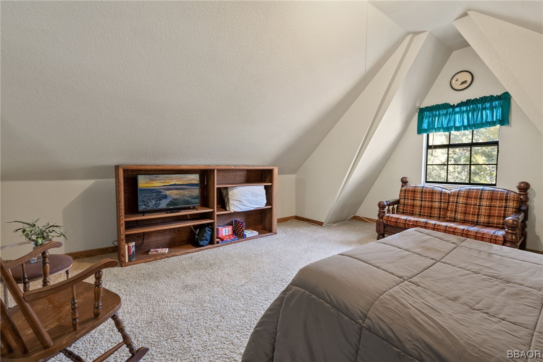 456 Riverside Avenue Sugarloaf, CA 92386 - Photo 13 of 19 a bedroom with a bed a window and a flat screen television