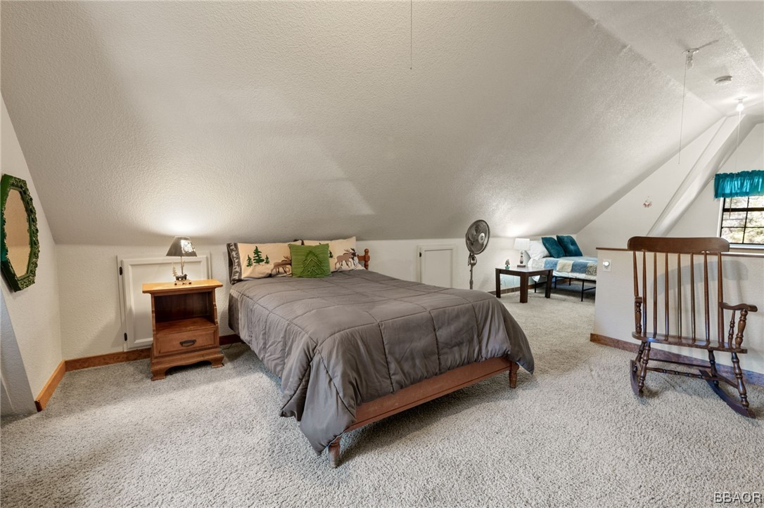 456 Riverside Avenue Sugarloaf, CA 92386 - Photo 14 of 19 a spacious bedroom with a bed and a cabinets