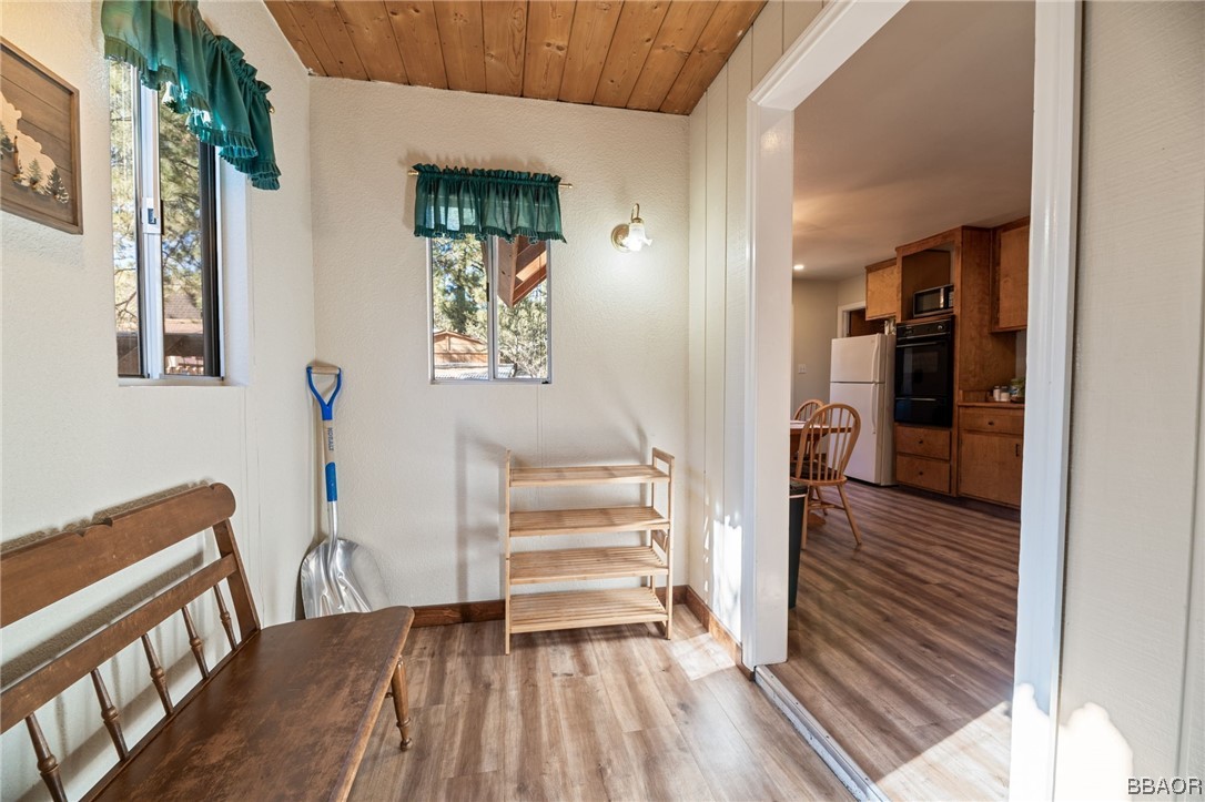 456 Riverside Avenue Sugarloaf, CA 92386 - Photo 3 of 19 a view of a hallway with wooden floor and staircase