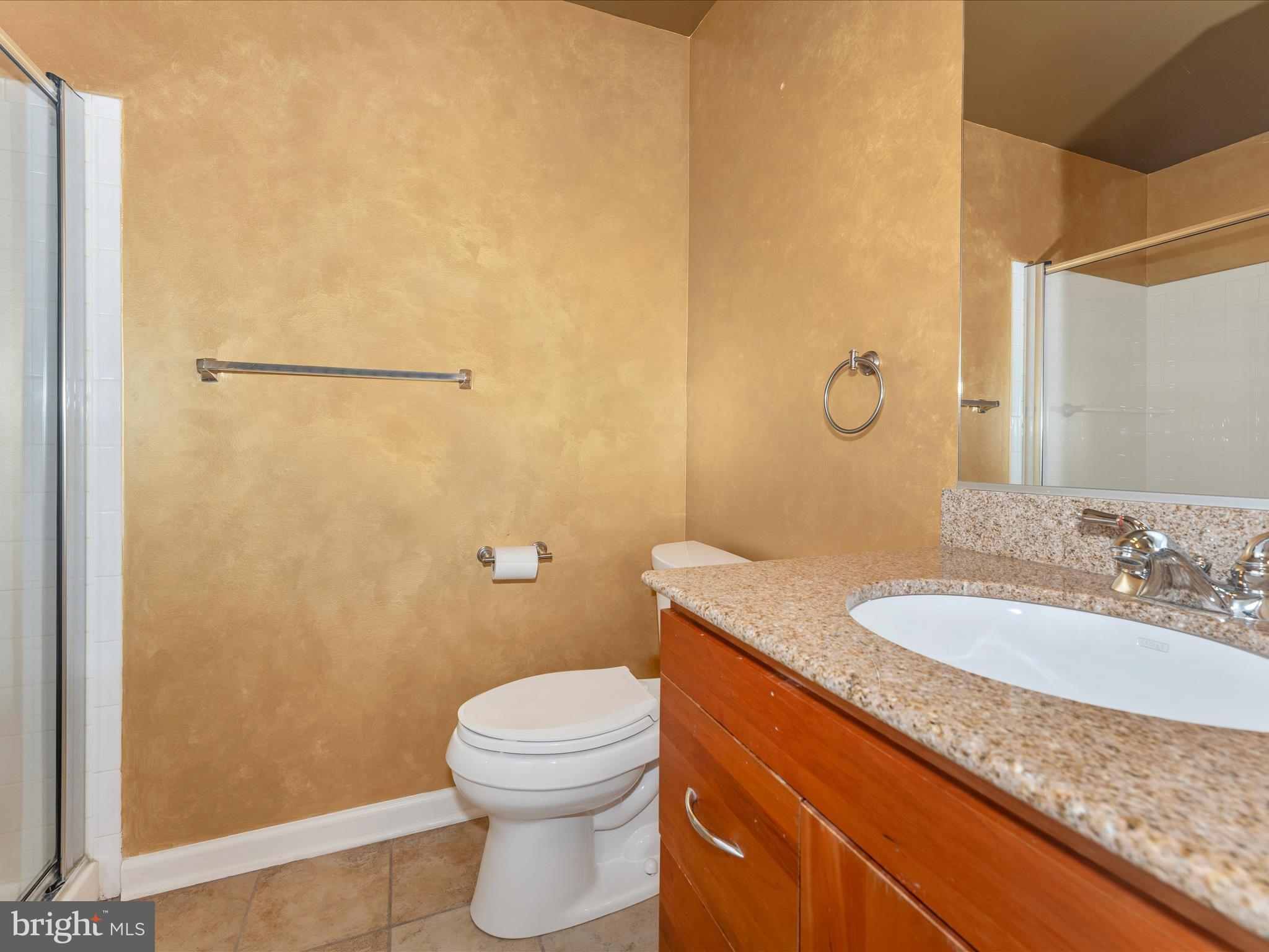 2050 Clipper Park Road Baltimore, MD 21211 - Photo 42 of 58 a bathroom with a granite countertop sink a mirror and a toilet