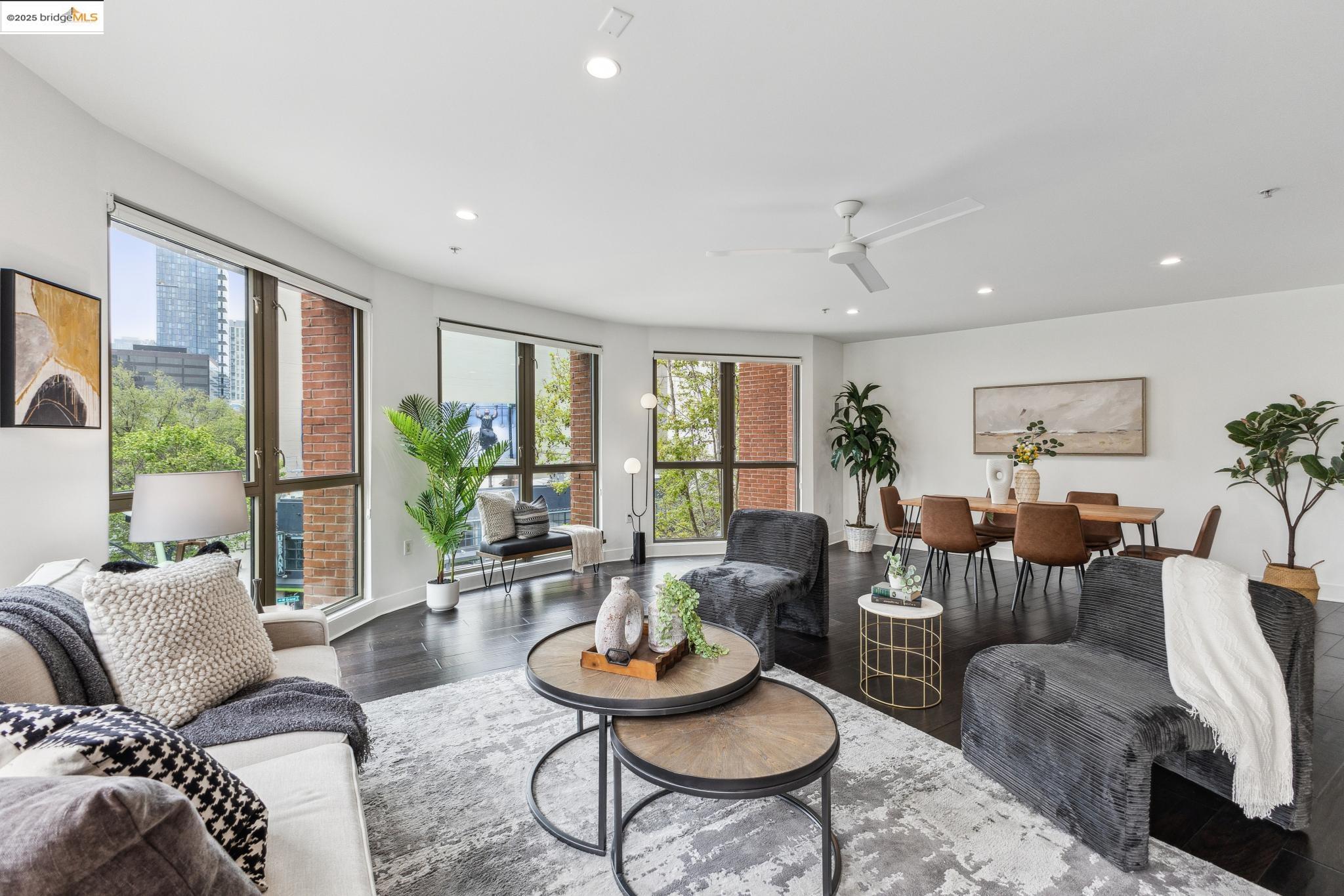 438 West Grand Avenue, Unit 420 Oakland, CA 94612 - Photo 1 of 58 a living room with furniture and a large window