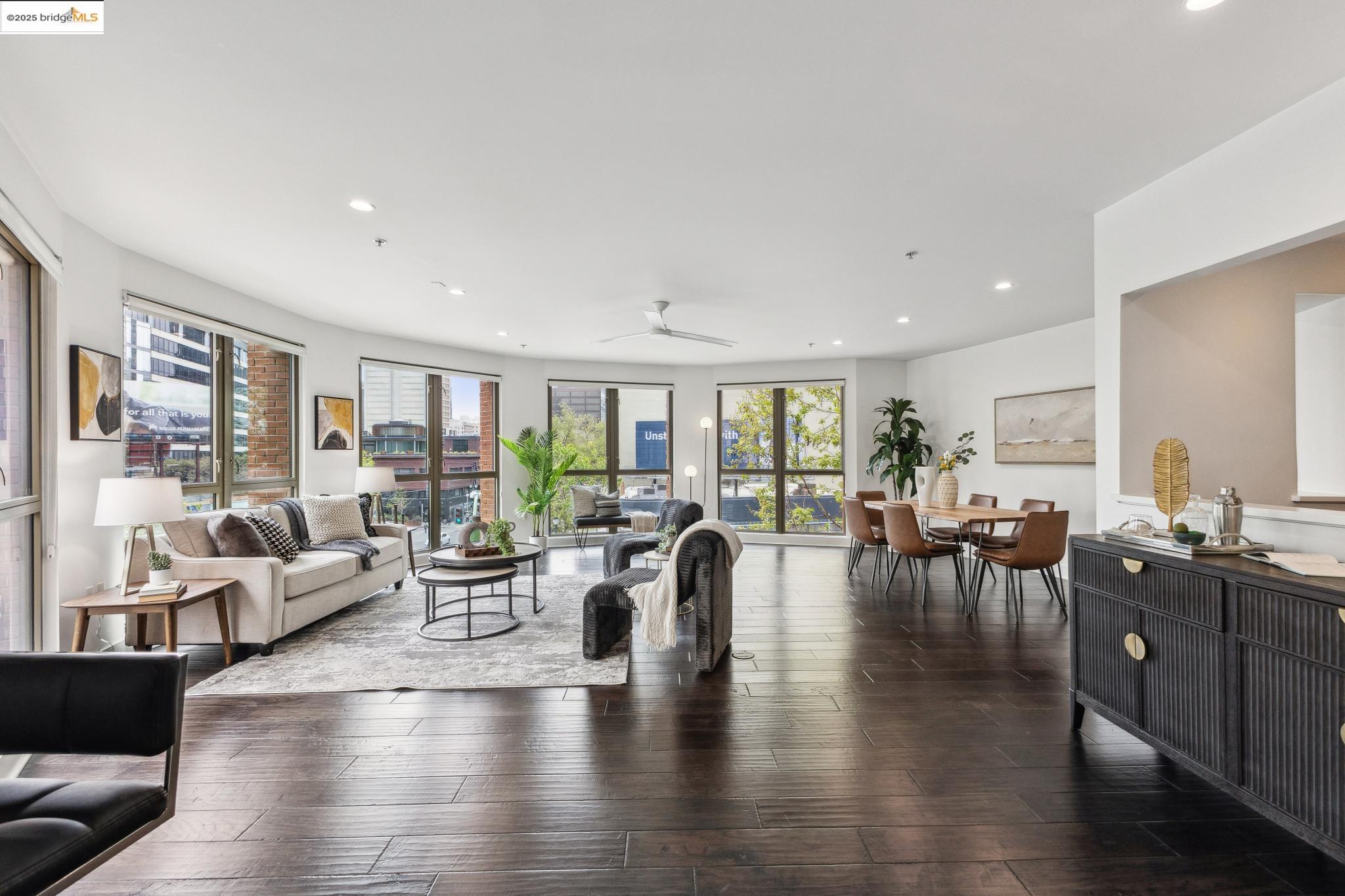 438 West Grand Avenue, Unit 420 Oakland, CA 94612 - Photo 13 of 58 a living room with lots of furniture wooden floor and a large window