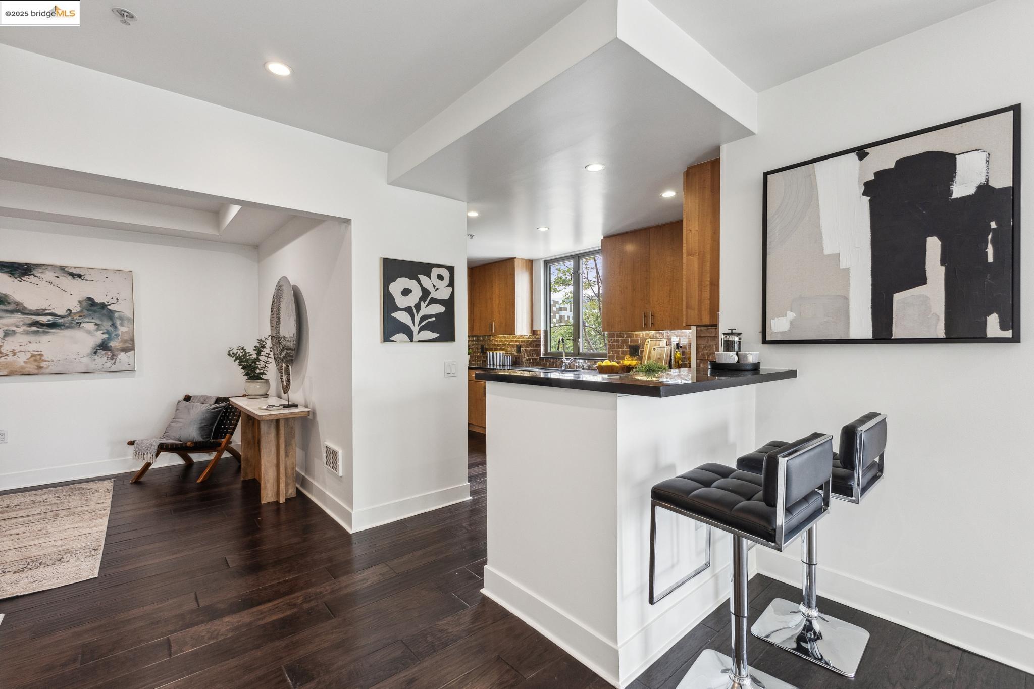 438 West Grand Avenue, Unit 420 Oakland, CA 94612 - Photo 14 of 58 a kitchen with stainless steel appliances kitchen island granite countertop wooden cabinets and granite counter tops