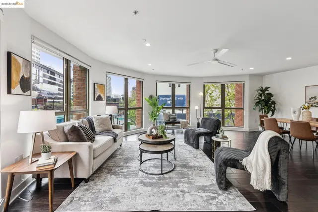 a living room with furniture potted plant and a large window