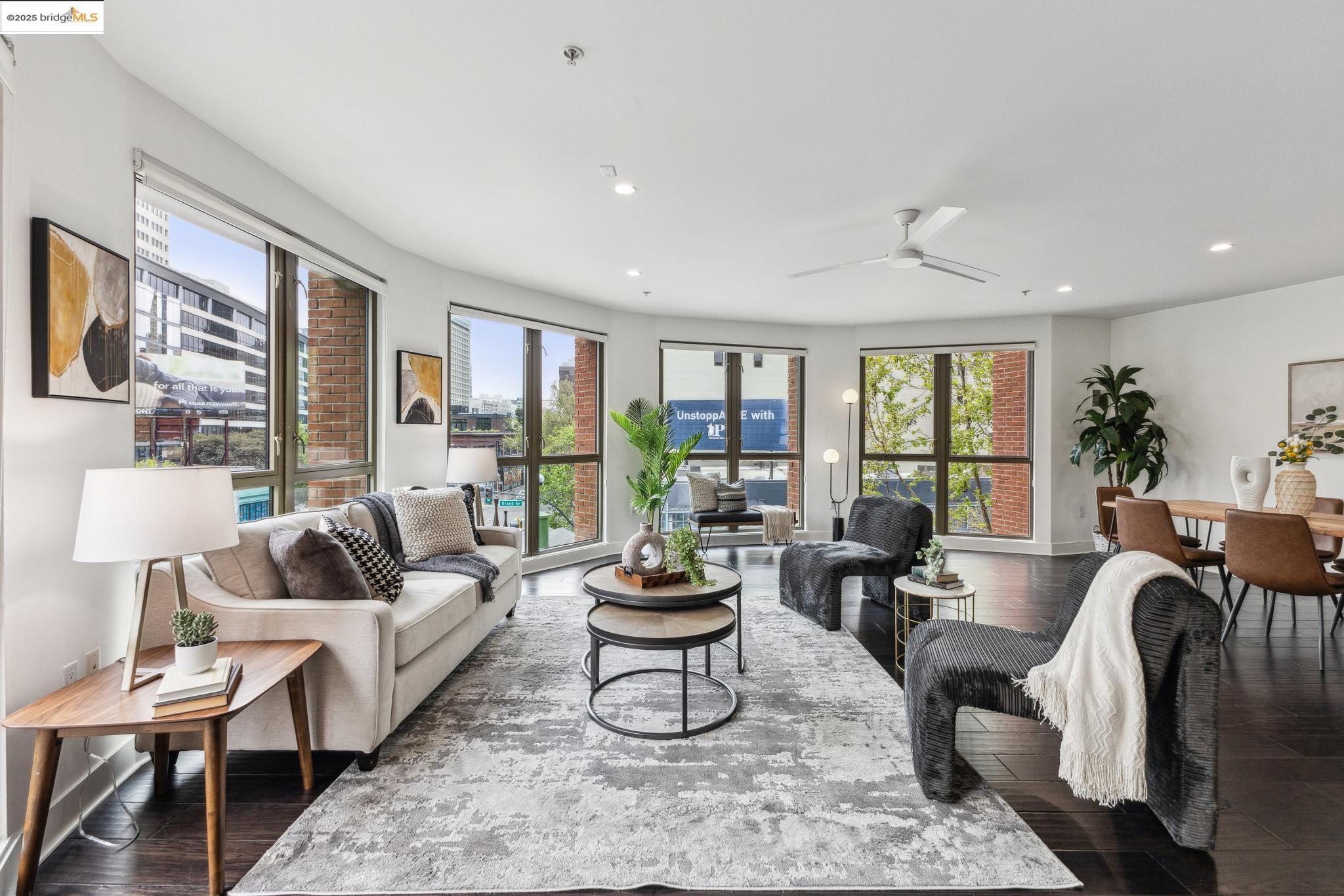 438 West Grand Avenue, Unit 420 Oakland, CA 94612 - Photo 16 of 58 a living room with furniture potted plant and a large window