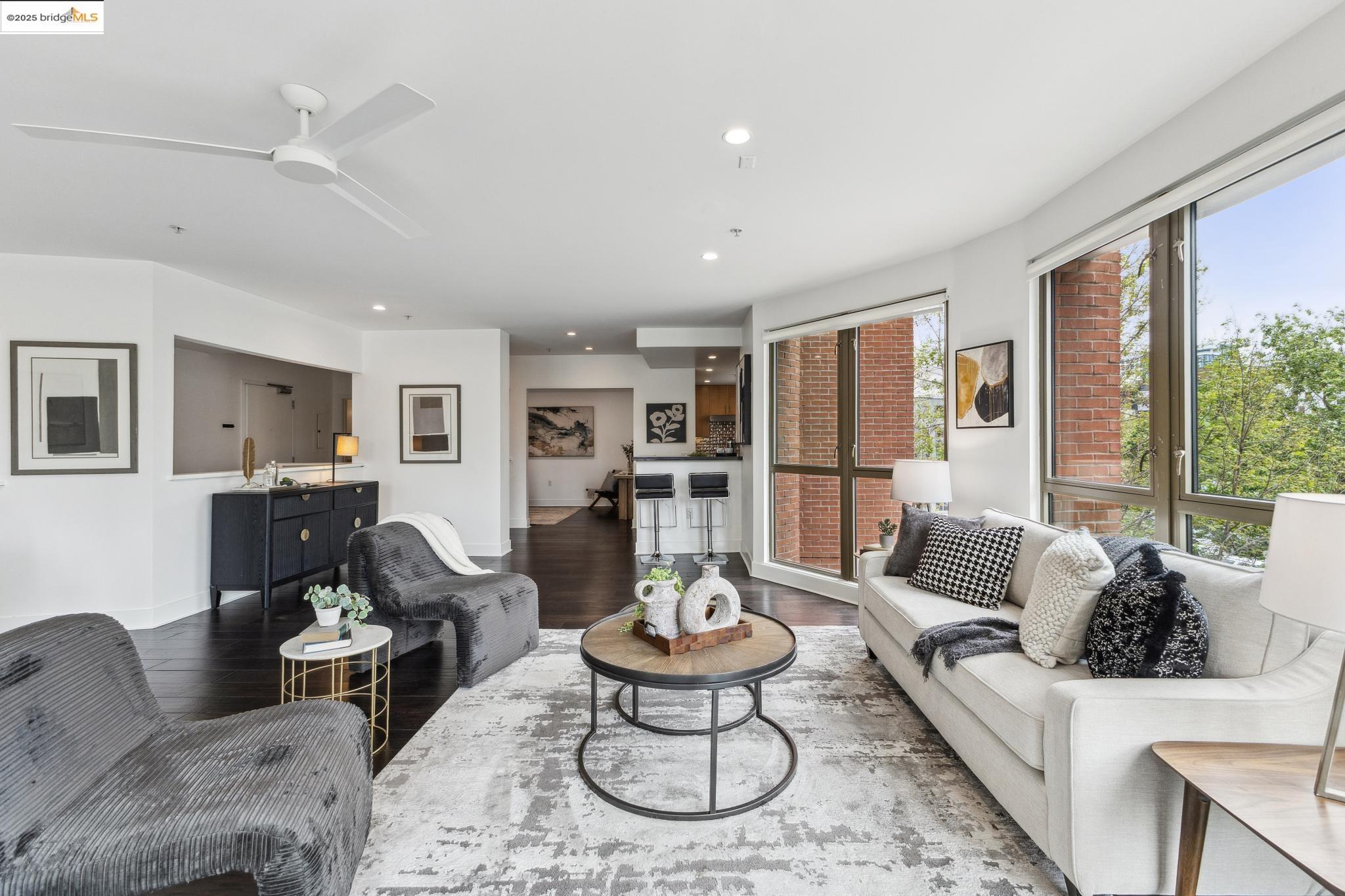 438 West Grand Avenue, Unit 420 Oakland, CA 94612 - Photo 17 of 58 a living room with furniture potted plant and a large window