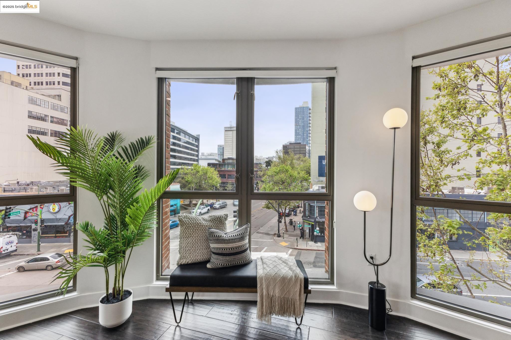 438 West Grand Avenue, Unit 420 Oakland, CA 94612 - Photo 18 of 58 a living room with furniture and a potted plant