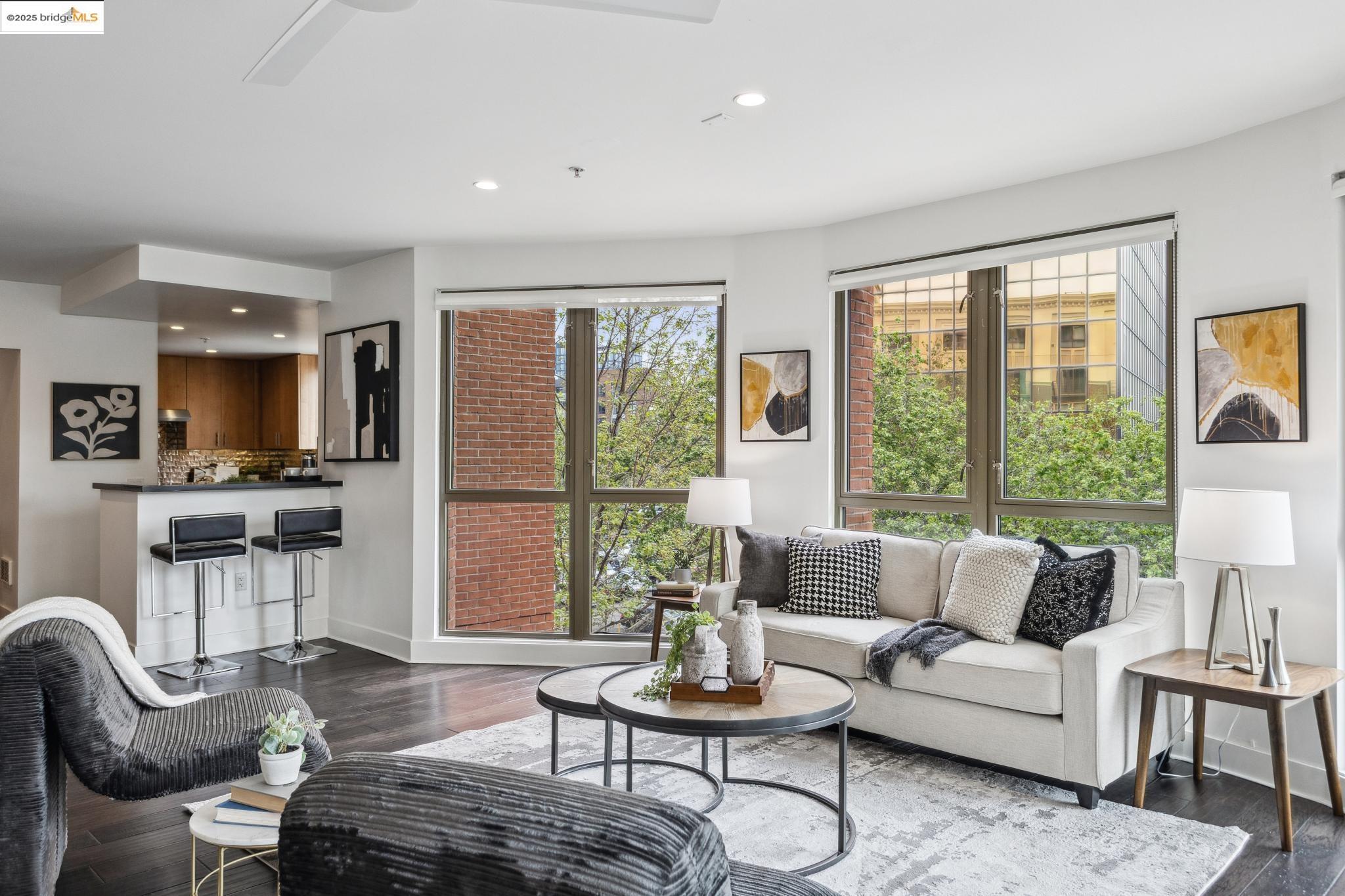 438 West Grand Avenue, Unit 420 Oakland, CA 94612 - Photo 23 of 58 a living room with furniture and floor to ceiling windows