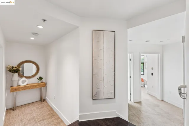 a bedroom with a large bed and a potted plant