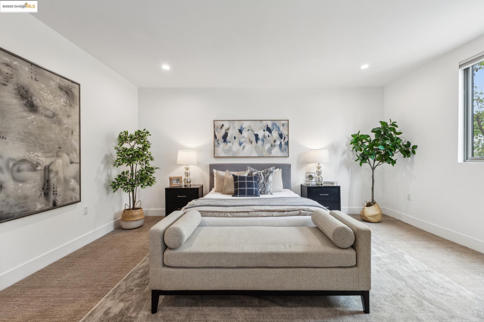 438 West Grand Avenue, Unit 420 Oakland, CA 94612 - Photo 28 of 58 a bedroom with a large bed and a potted plant