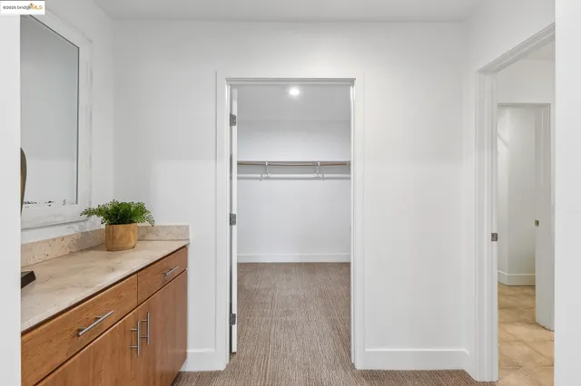 a room with a sink and mirror
