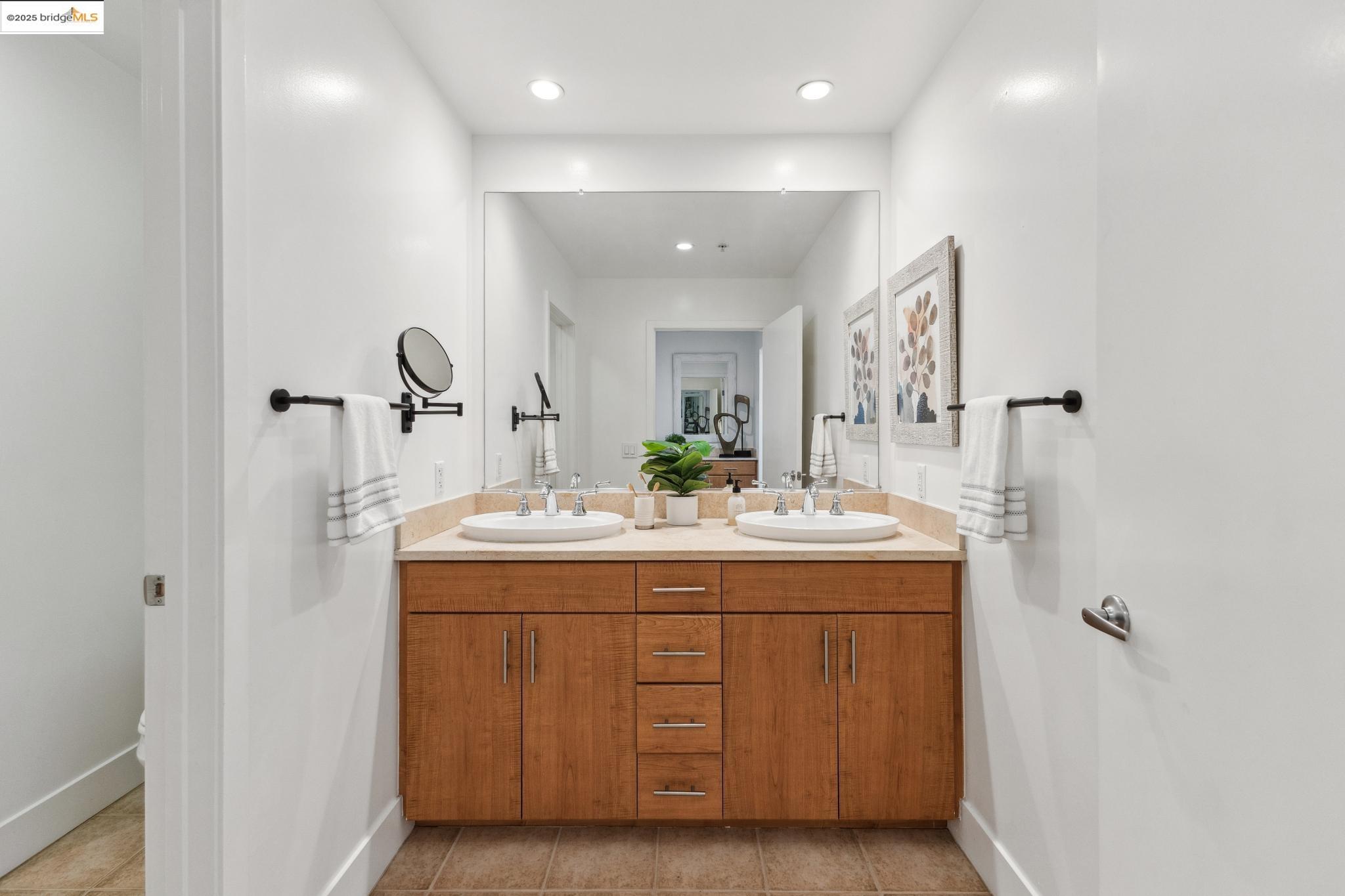 438 West Grand Avenue, Unit 420 Oakland, CA 94612 - Photo 34 of 58 a room with a sink and mirror