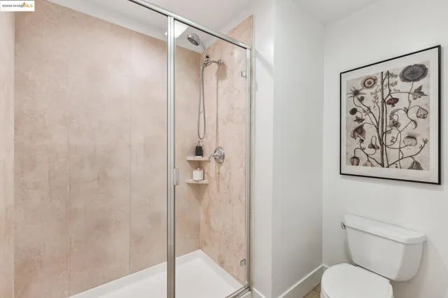 a bathroom with a granite countertop toilet sink and mirror