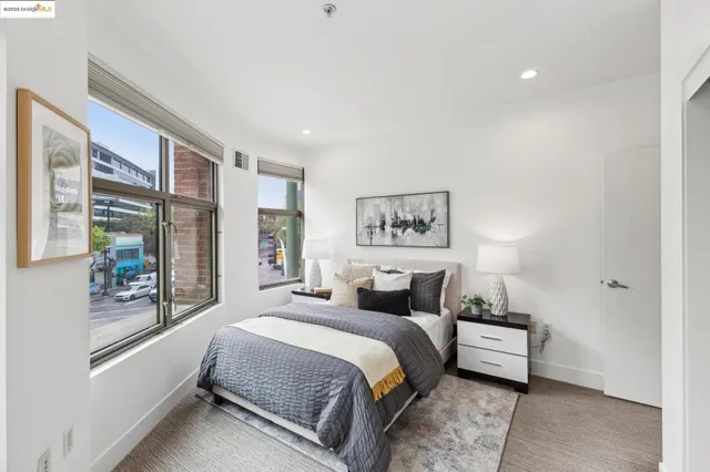 a bedroom with a bed and a large window