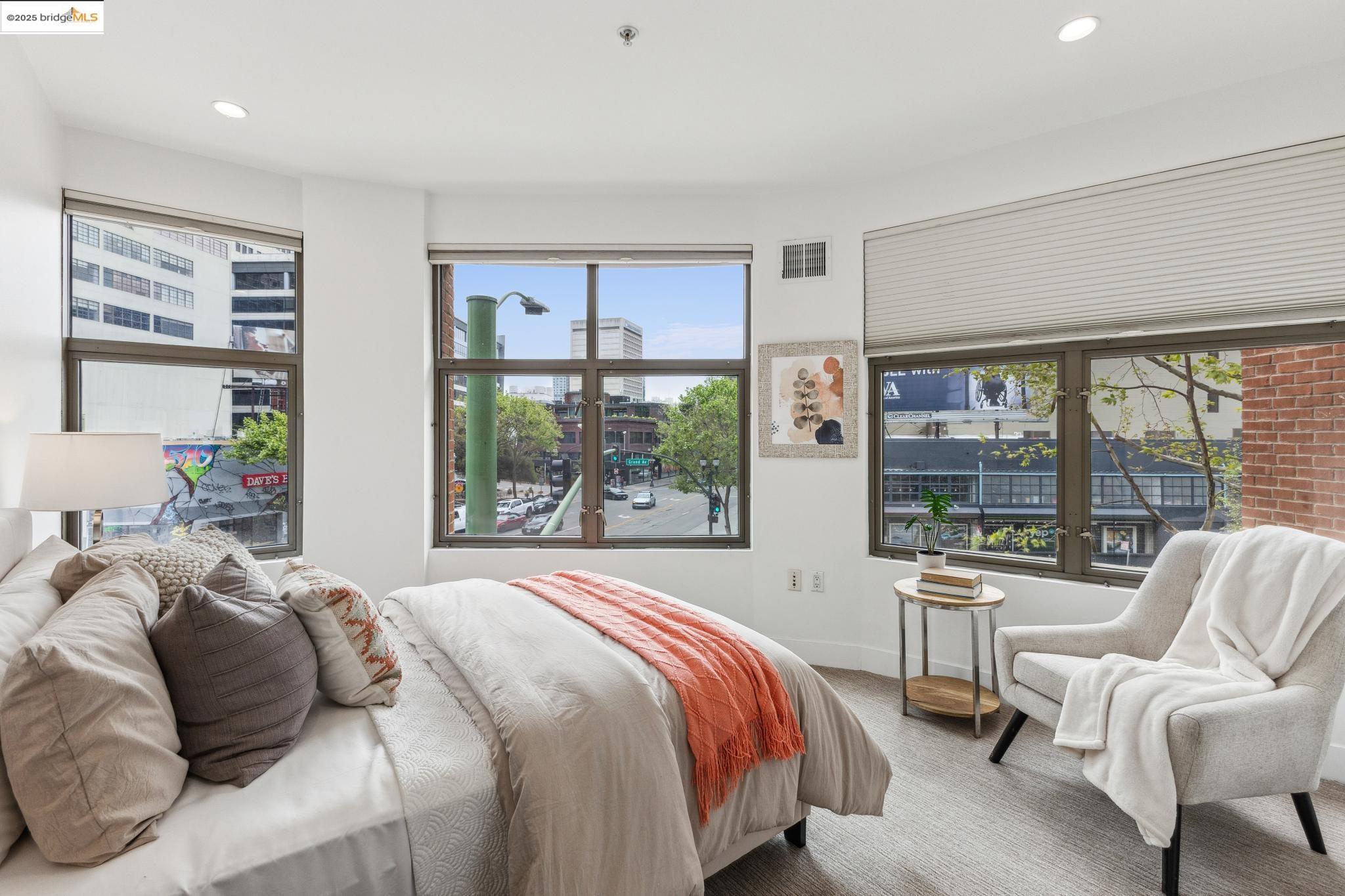 438 West Grand Avenue, Unit 420 Oakland, CA 94612 - Photo 40 of 58 a bedroom with a bed and a large window