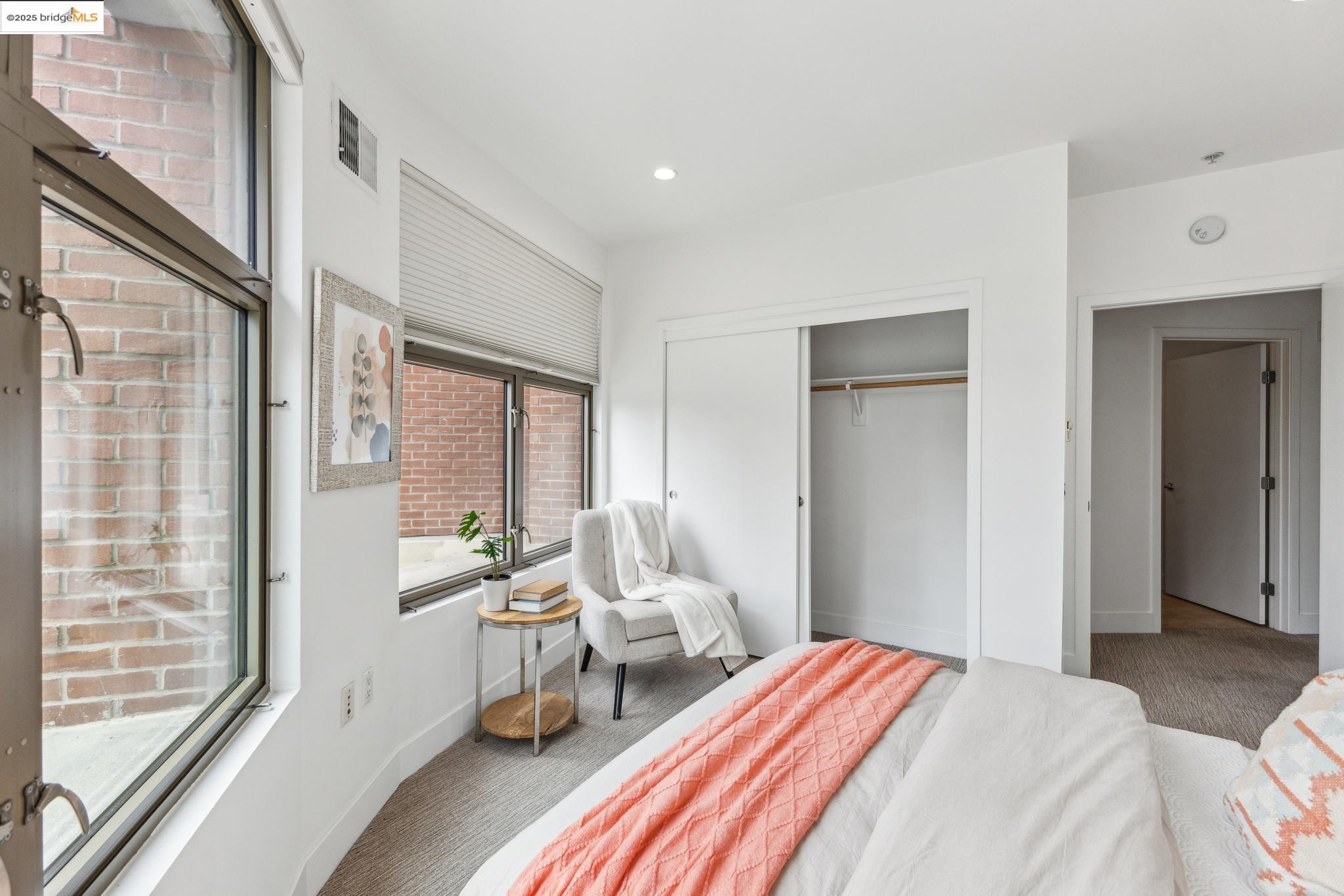 438 West Grand Avenue, Unit 420 Oakland, CA 94612 - Photo 41 of 58 a bedroom with a bed and large windows