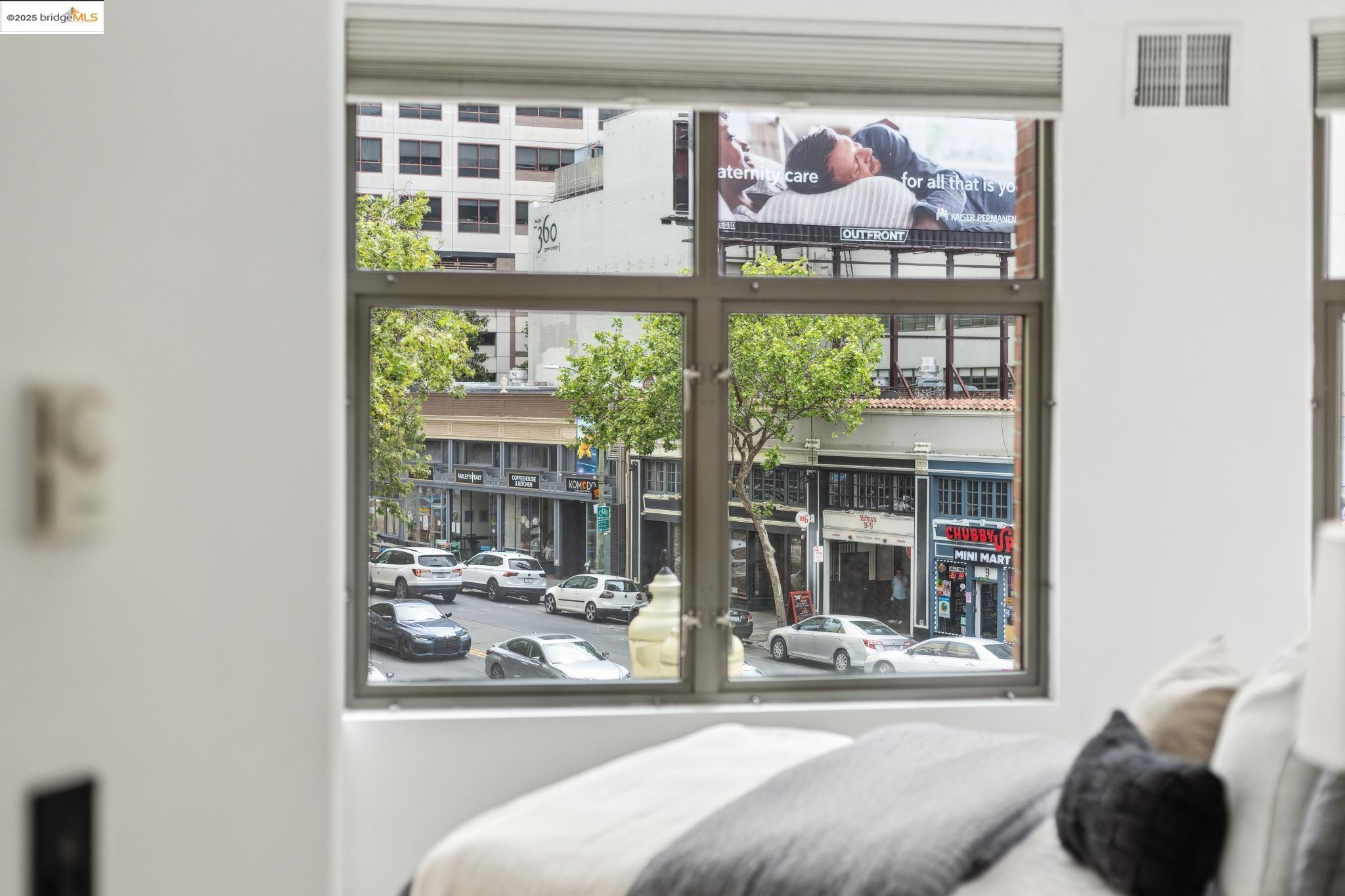 438 West Grand Avenue, Unit 420 Oakland, CA 94612 - Photo 43 of 58 a living room with a large window and a table
